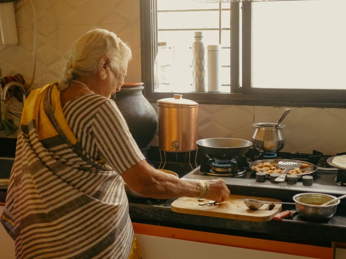Elderly woman cooking in a home kitchen