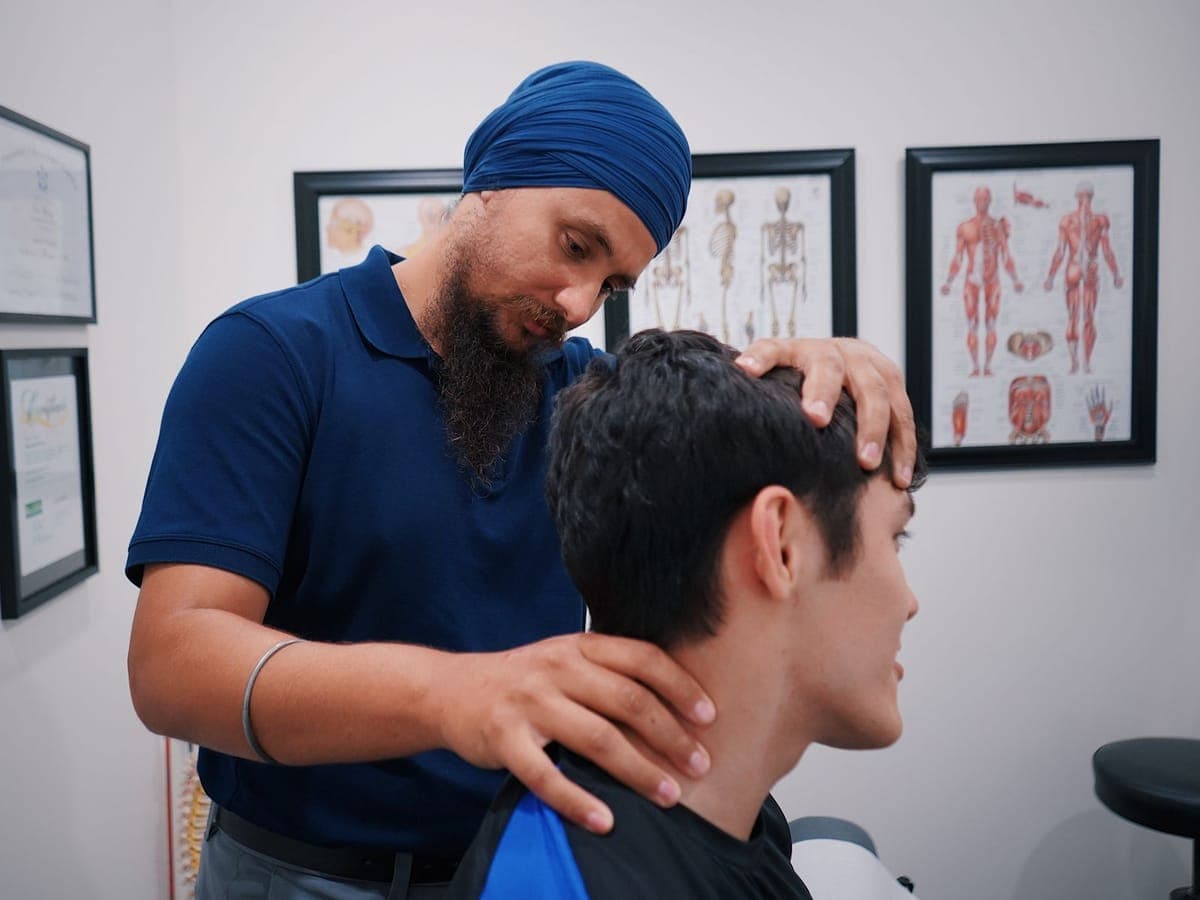 Physiotherapist treating a patient's neck